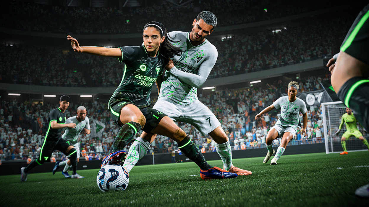 A player guards the ball against the opposing team in front of a crowd.